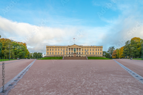 Front view of the Royal Palace and The equestrian statue of King Karl III Johan of Norway and Sweden stand in front of and blue sky in morning summer. Oslo, Norway.