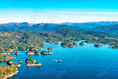 Fototapeta Naklejka Na Ścianę i Meble -  Beautiful aerial view of fjord landscape with small village  and ferry on the ocean near Bergen, Norway