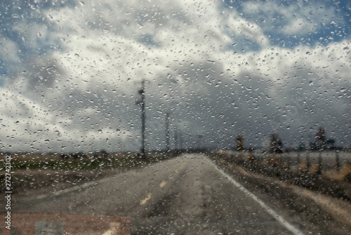 Roadway up ahead as seen through a rainy windshield. © Kirk