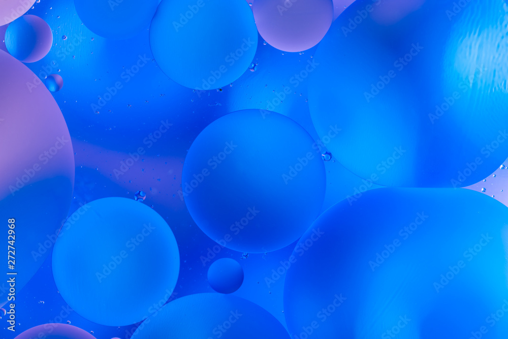 oily drops in water with colorful background, close-up oily drops in water with colorful background, close-up