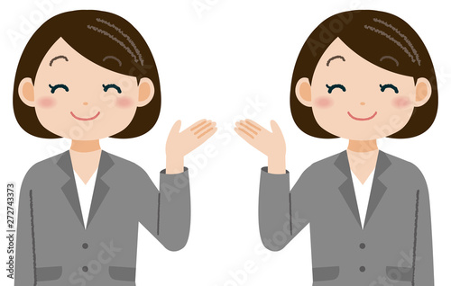 笑顔で手を差し出すスーツの女性　案内