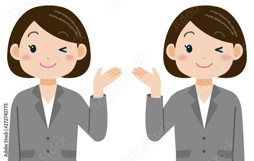 ウインクして手を差し出すスーツの女性　案内