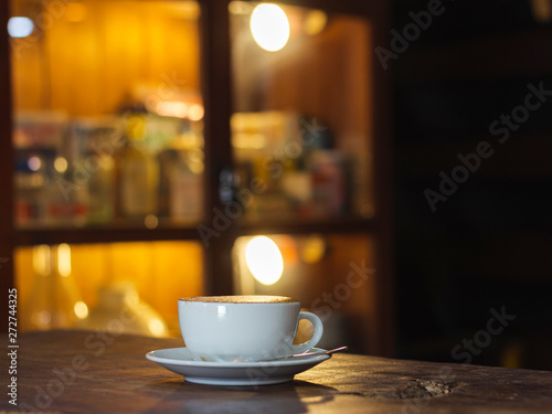 Cup of coffee on wooden table in the coffee shop.