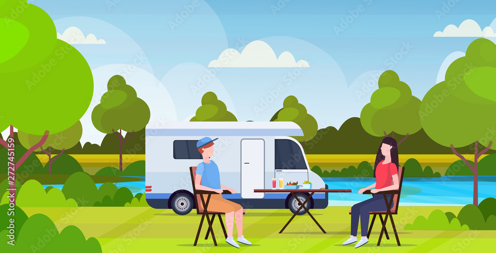 Fototapeta premium couple sitting at table near camping family trailer truck caravan car man woman spendingtime togeher summer vacation concept beautful nature landscape background flat full length horizontal