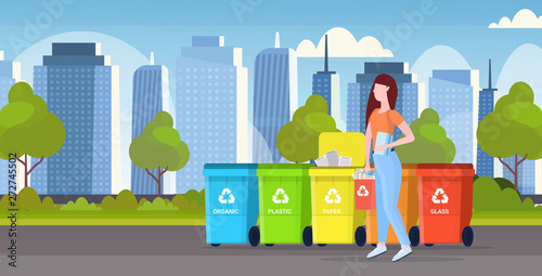 womanputting bucket with paper rubbish in container different types of recycling bins segregate waste sorting management concept modern cityscape background flat horizontal full length