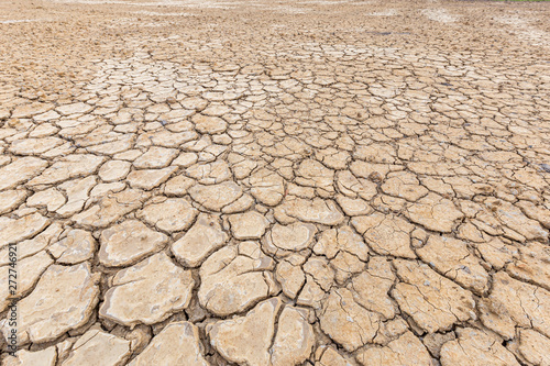 Brown dry soil or cracked ground texture background.