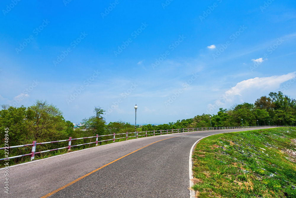 road view reservoir green tree with green nature forest in the hill and blue sky background.