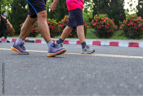  legs of couple man exercise with walking at the park.
