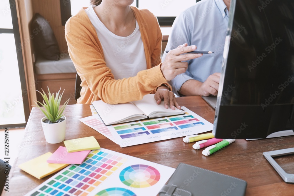 Graphic designer working on digital tablet. artist drawing on graphic tablet and Color swatch samples