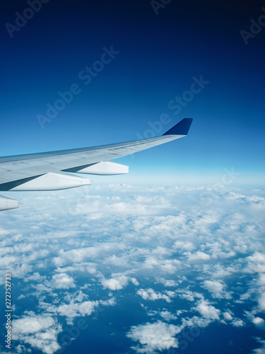 View from the plane. White clouds and blue sky from the airplane