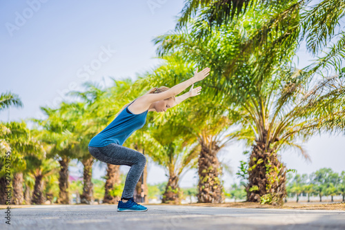 Woman doing yoga in a tropical park
