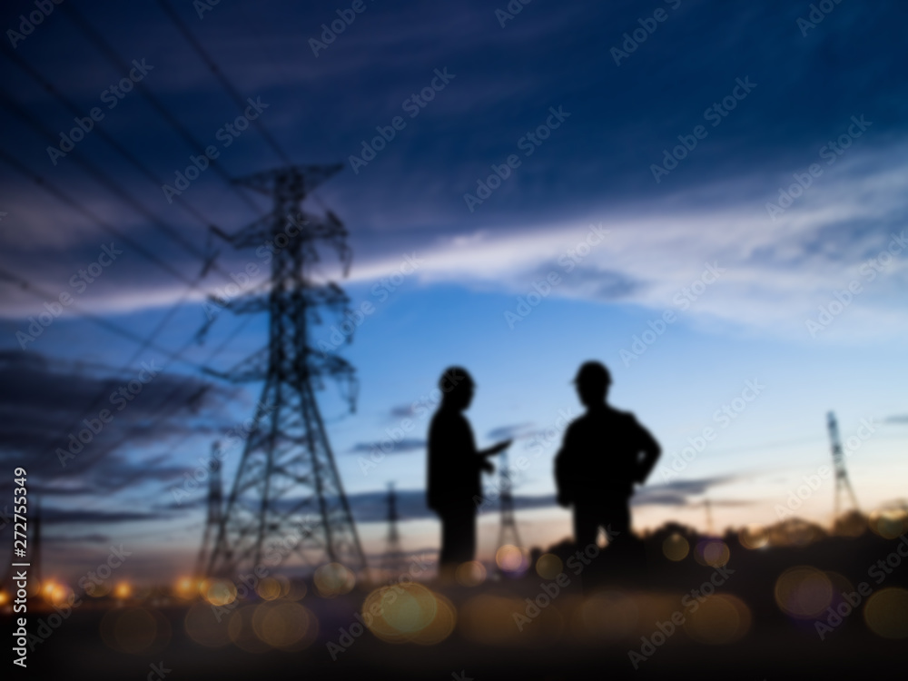 abstract bokeh background glitter and vintage lights background over Silhouette of engineer and construction team working at site. The party celebrating the success of important projects