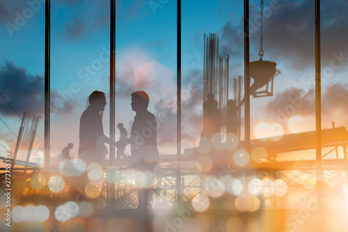 abstract bokeh background glitter and vintage lights background over Silhouette of engineer and construction team working at site. The party celebrating the success of important projects