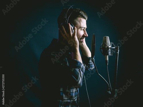 The young guy singing in recording studio
