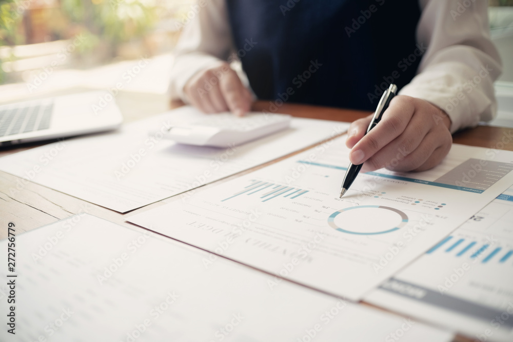 Accountant working with data documents calculating on business report. Accountant working with data documents calculating on business report.