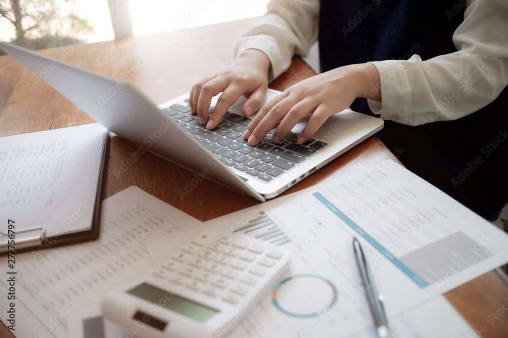 Accountant working with data documents calculating on business report. Accountant working with data documents calculating on business report.