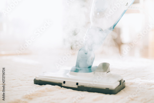 Cleaning the floor with steam cleaner. Banner and copy space. Cleaning service concept photo