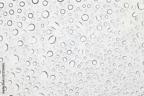 Water drops on glass, Rain droplets on glass background. © peterkai