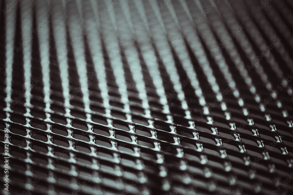 Surface of latticed metal fence. Stainless steel and aluminum light blur background. Macro texture Surface of latticed metal fence. Stainless steel and aluminum light blur background. Macro texture