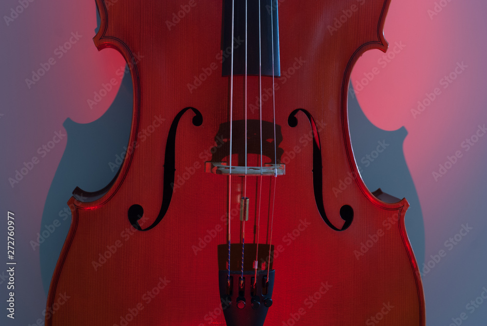 Fototapeta Details of musical instrument cello with light and shadow