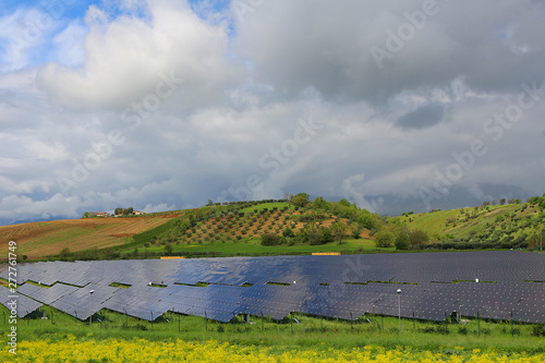 Cultivated landscape with solar panels fields surrounded by olive groves in Calabria  Italy 