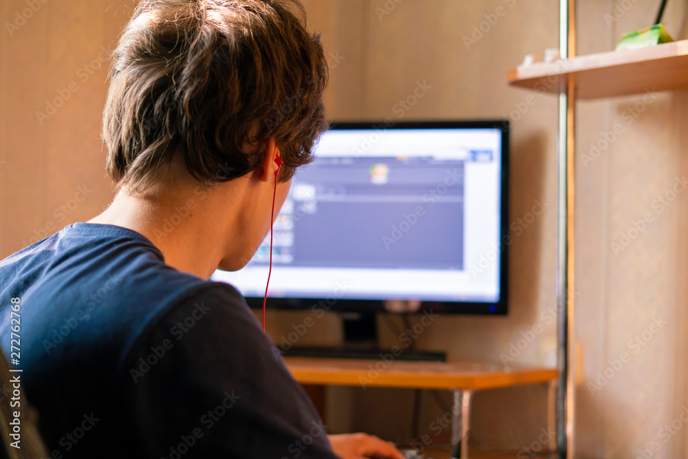 young man working with computer and typing on a keyboard at home, freelancer concepts young man working with computer and typing on a keyboard at home, freelancer concepts
