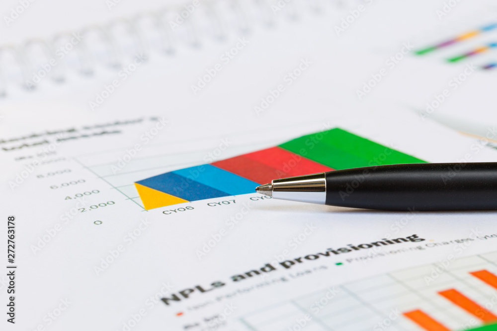 Financial report graph with pen on the table Financial report graph with pen on the table