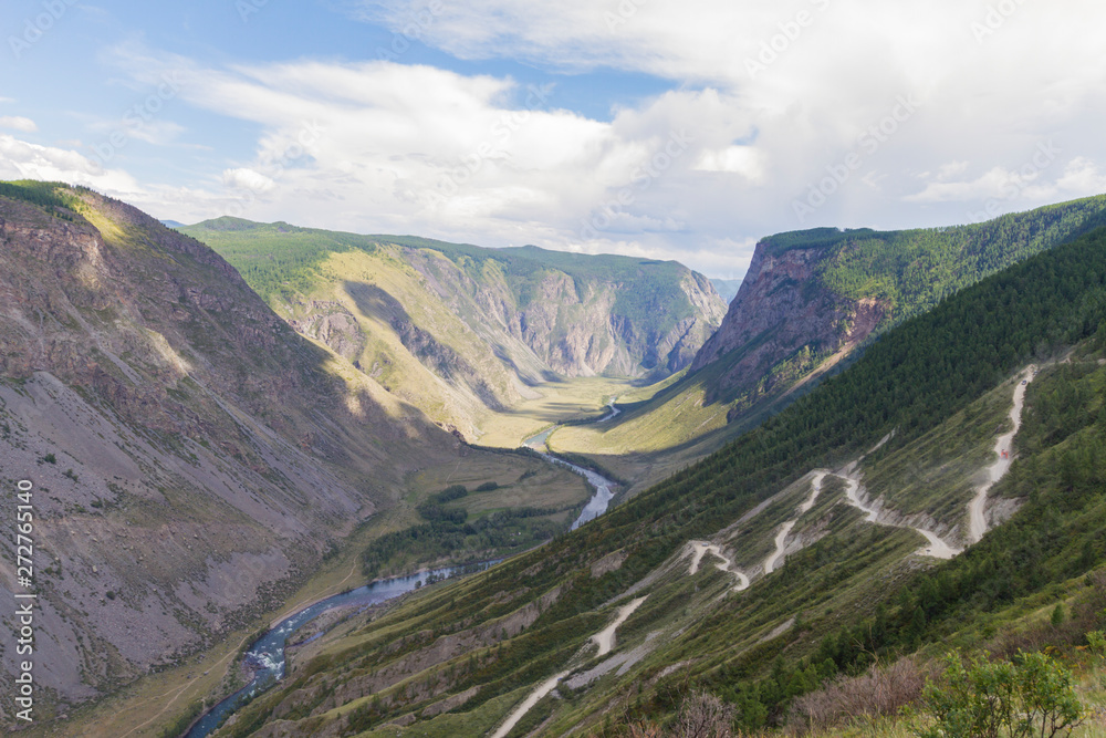 Valley of the river, top view. Altay mountains. Summer sunny day. Mountain car pass