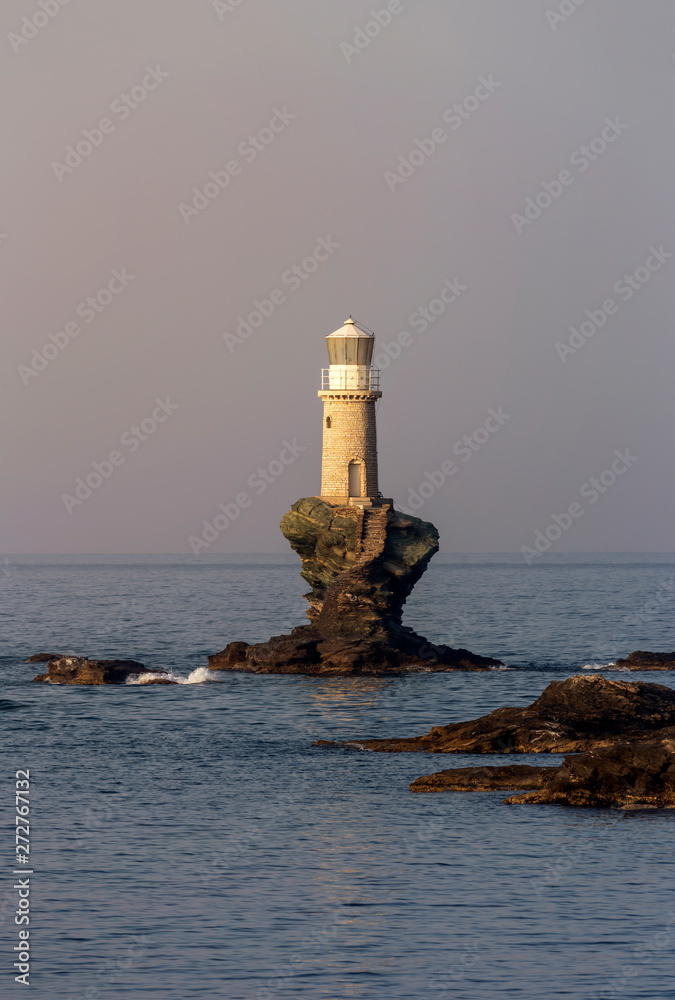 View of the town lighthouse Tourlitis and the sea (Greece, island Andros, Cyclades)