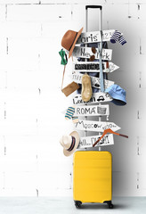 Travel suitcase with wooden signs and hanging clothes and accessories