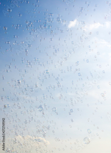 Soap bubbles fly in the blue sky