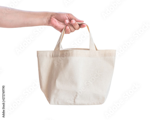Tote bag canvas white cotton fabric cloth for eco shoulder shopping sack mockup blank template isolated on white background (clipping path) with woman’s hand handling handle straps