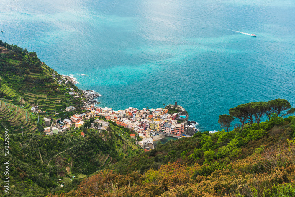 Stunning view over the colorful town of Vernazza in Cinque Terre, Italy, as seen from the hiking trail passing above it. Landscape of an old italian coastal  village at the Ligurian Sea.