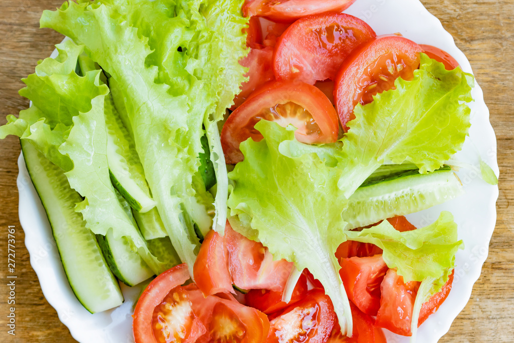 Fresh vegetables separately lying on a plate Fresh vegetables separately lying on a plate