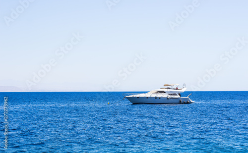 cruise vacation summer photography of white yacht on Red sea smooth blue water surface in bright clear weather time, copy space for text or some inscription  © Артём Князь