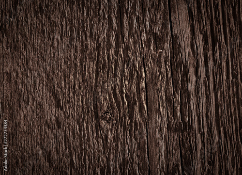 Texture of dark brown old rough wood. Abstract background for design. Vintage retro