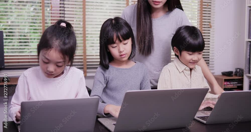 Group of student using laptop together at classroom. Teacher training children to use computer. Technology and Education concept. Group of student using laptop together at classroom. Teacher training children to use computer. Technology and Education concept.