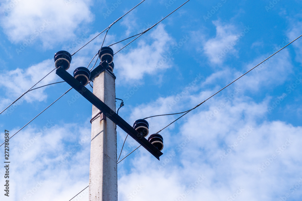 A pole with electrical wires under tension.