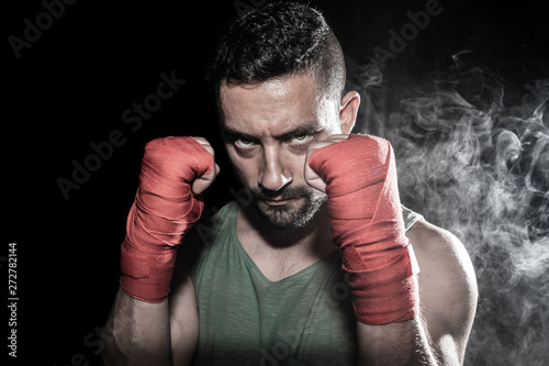Wrestler with gloves and black background © Sergio