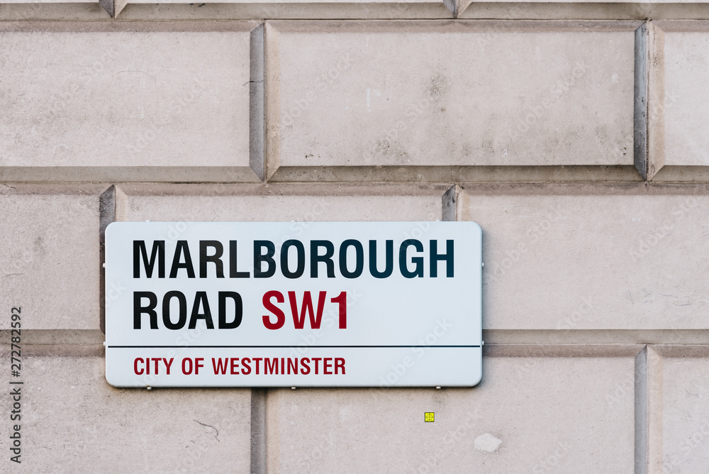 Street name sign on stone wall in London Street name sign on stone wall in London