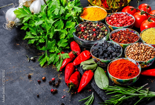 Fototapeta Naklejka Na Ścianę i Meble -  Various herbs and spices on black stone plate