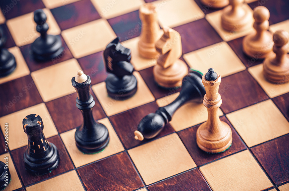 Chess board with wooden chess pieces on the table Chess board with wooden chess pieces on the table