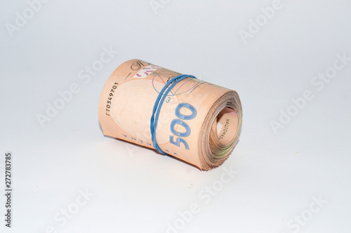 Ukrainian money on five hundred hryvnia isolated on a white background, rolled into a roll, tube. Side view, copy space