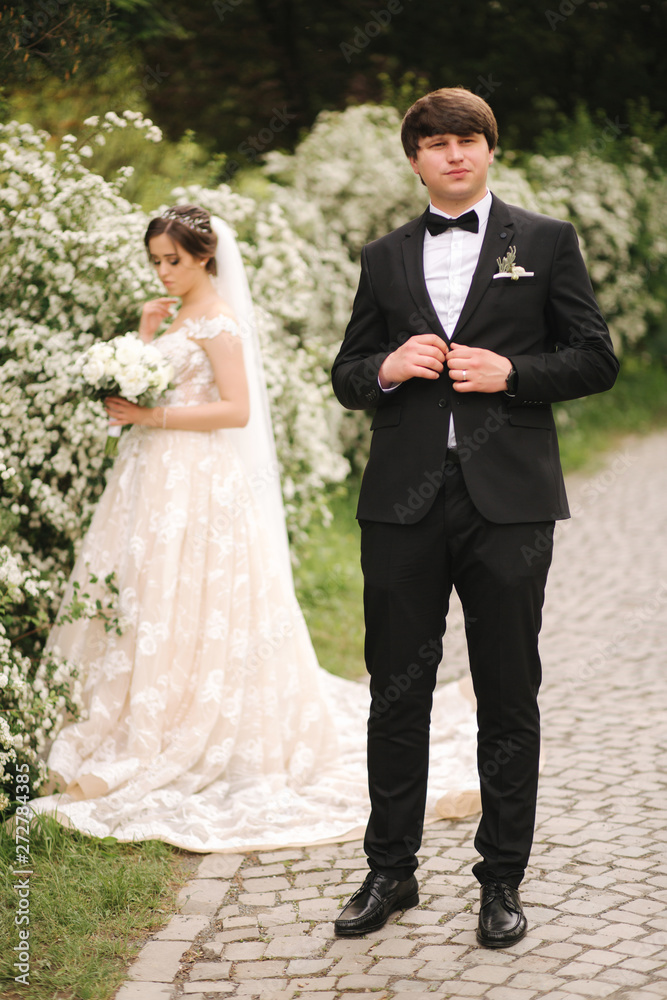 Handsome groom staind in front of beutiful bride Handsome groom staind in front of beutiful bride