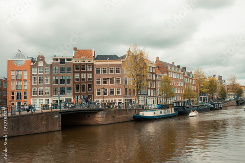 Canal, houses and bikers in Amsterdam city center