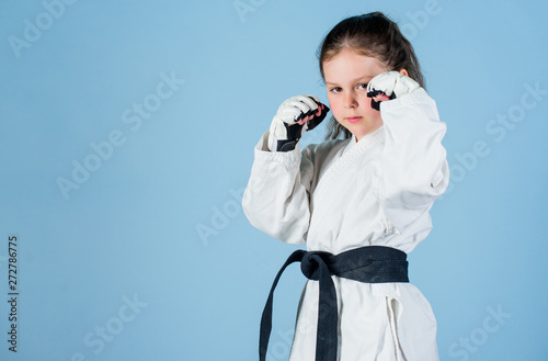 knockout. energy and activity for kids. practicing Kung Fu. happy childhood. sport success in single combat. girl in martial arts uniform. little girl in gi sportswear. copy space. Ready to fight photo