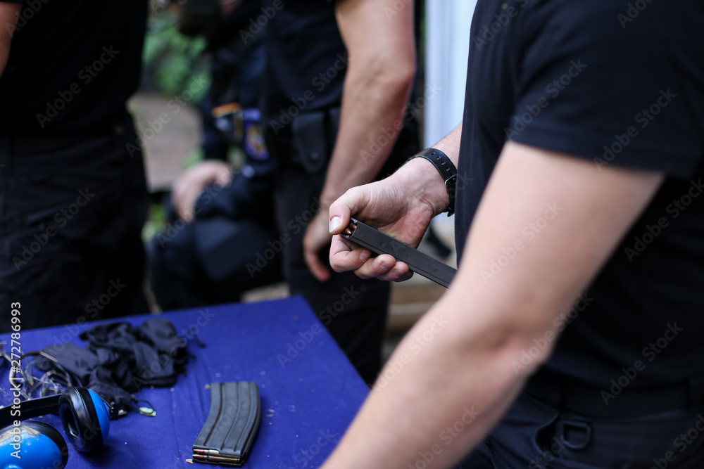 Man loading 9mm cartridges in a gun clip Man loading 9mm cartridges in a gun clip