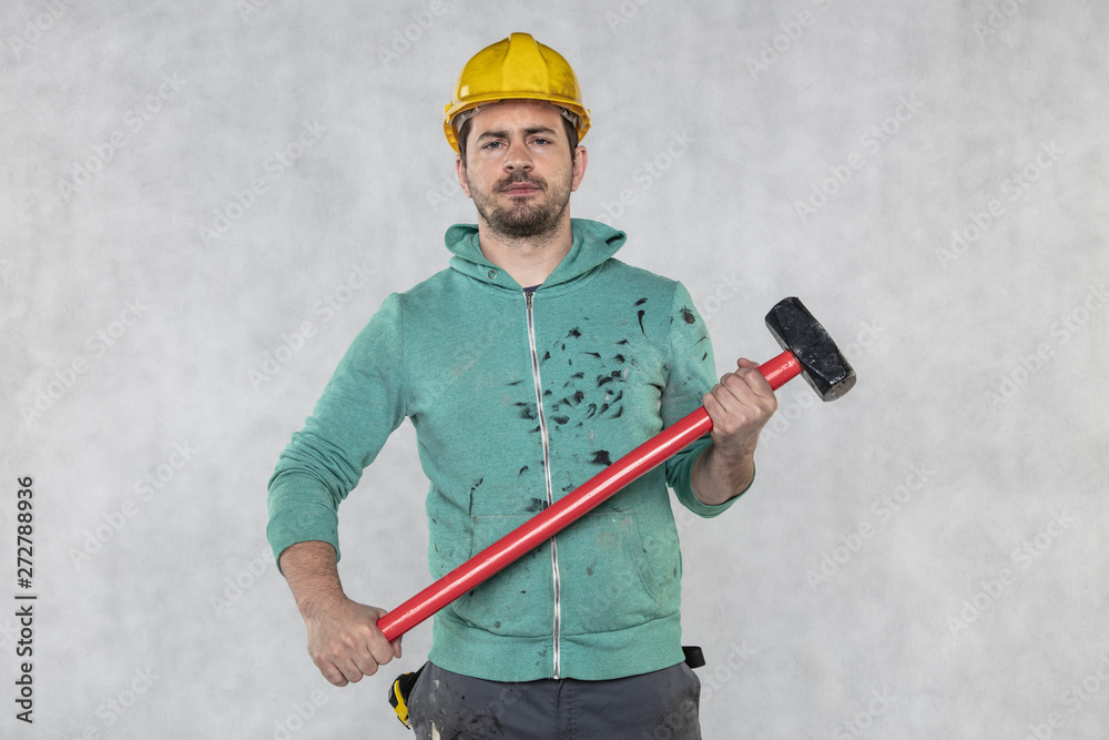 construction worker with a hammer in hand, concept of construction and disassembly, renovation construction worker with a hammer in hand, concept of construction and disassembly, renovation