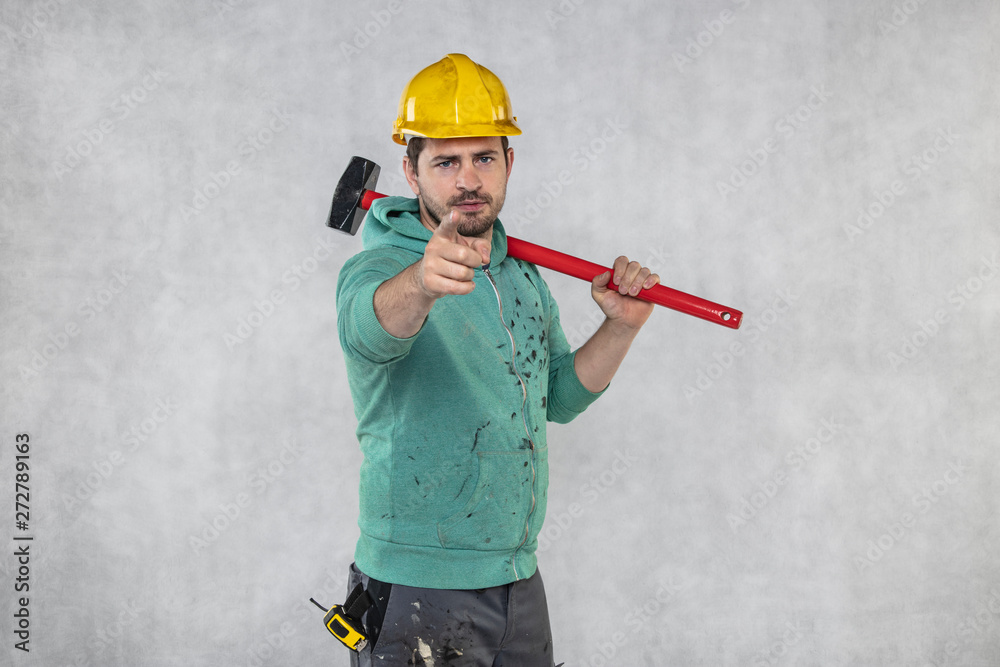 construction worker with a hammer in hand, concept of construction and disassembly, renovation construction worker with a hammer in hand, concept of construction and disassembly, renovation