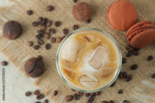 Ice latte or Iced coffee with milk and ice cubes in a glass beaker on a light background. refreshing drink. summer drink. top view